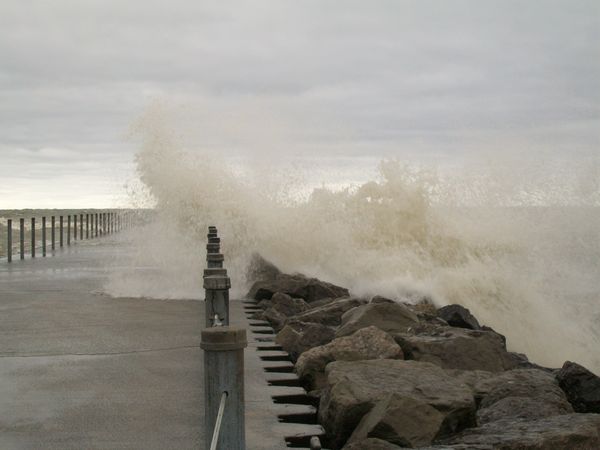 storm waves breaking on pier on lake ontario...