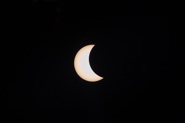 Partial eclipse with sunspots at the 8 o'clock pos...