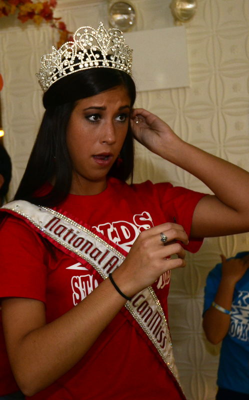 National American Miss Teen putting on her crown t...