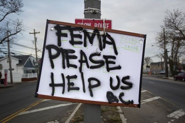 A sign asking for help from FEMA is seen in the Br...