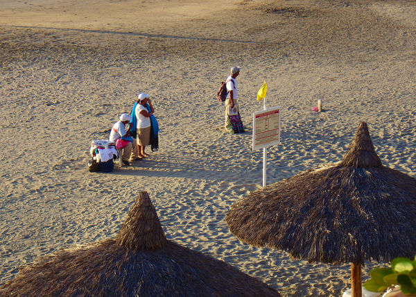 Beach vendors working the beach - few tourists and...