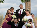 A family that makes funny faces at the wedding tog...
