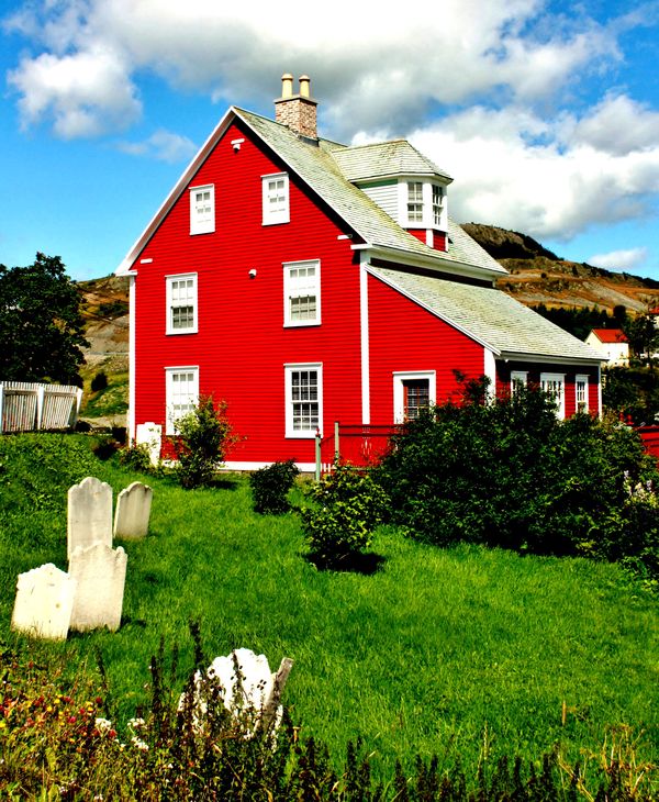 Lovely Red Home With Tombstones in the Yard...