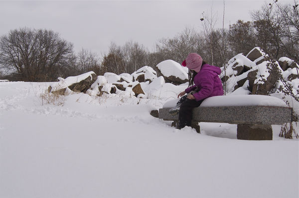 Resting on a snow covered granite bench....