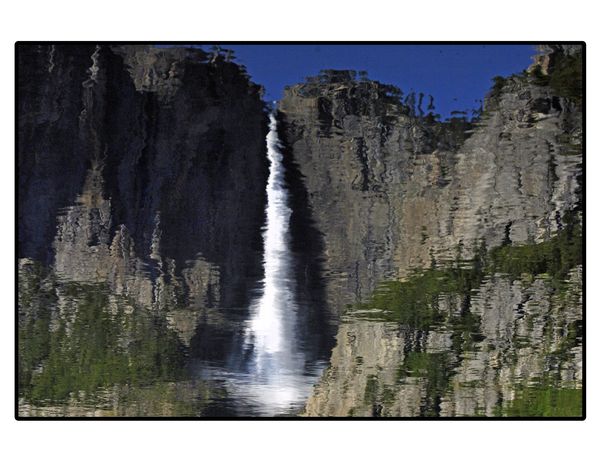 Reflection of Yosemite falls in Merced river...