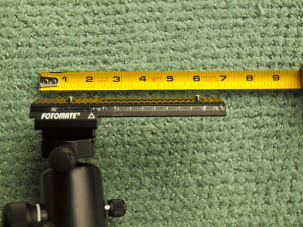 rail attached to tripod and in forward most positi...