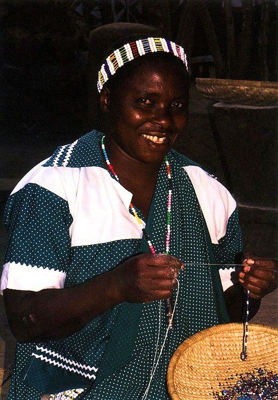 A Village Lady making beads...