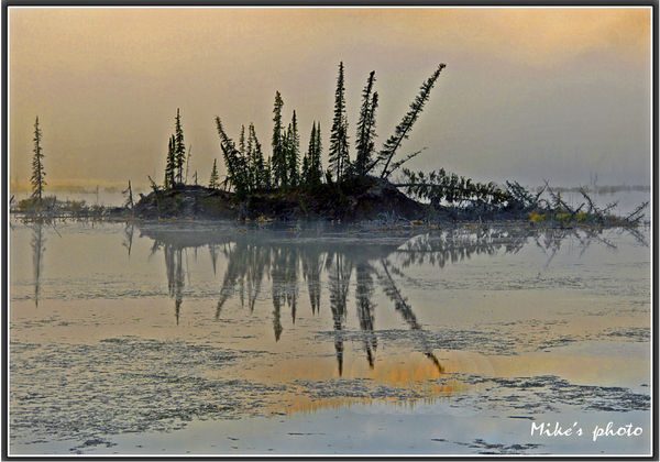 Fog and fall reflection at Mentasta lake Alaska....