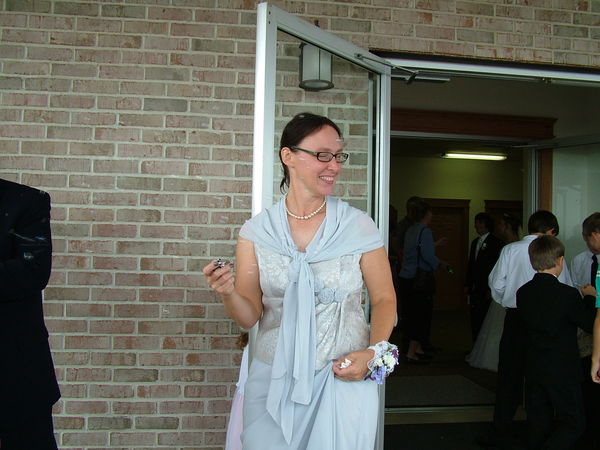 Mother of bride waiting outside to blow bubbles...