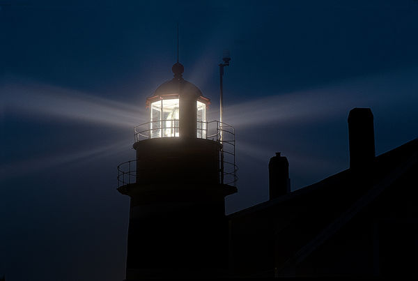 Lighthouse beacon penetrates light early morning f...