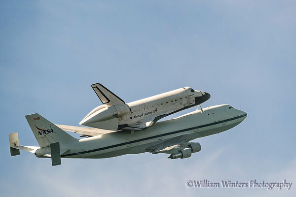 Shuttle Endeavour flying away towards the Queen Ma...