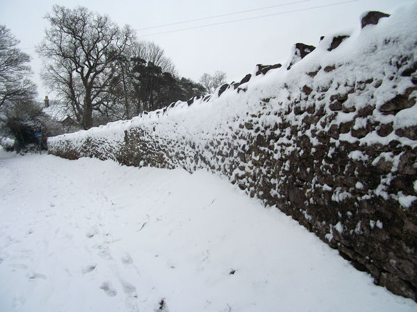 Snow on stone wall...