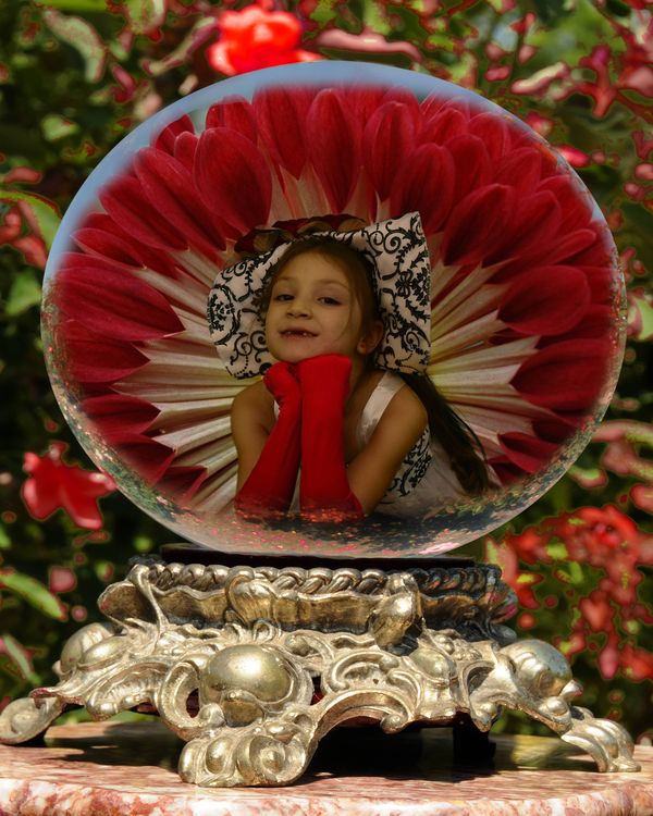 Sena in a globe in front of red flower I took at L...