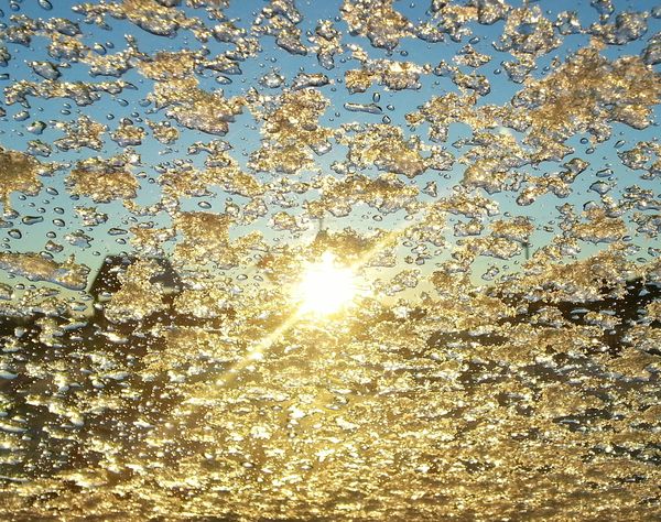 Winter view of sunrise through icy Windshield...