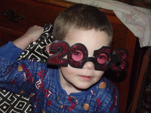 Grandson playing with my new year glasses....