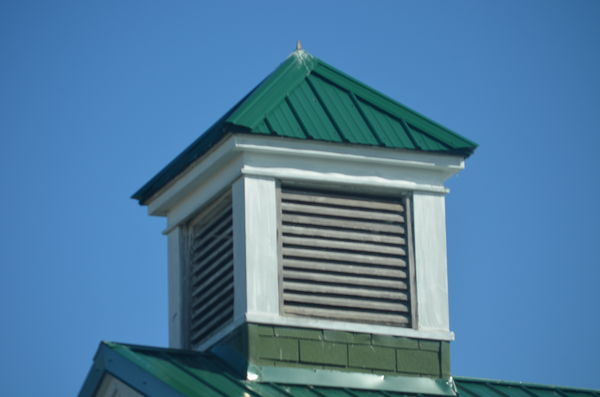 This cupola on an old church has a green roof....
