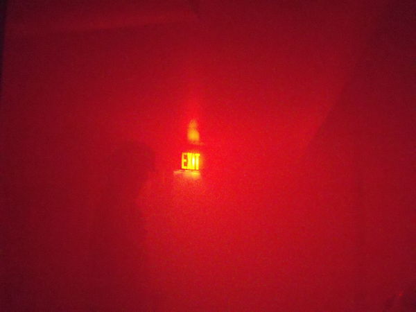 The RED light from the EXIT sign is visible in the...