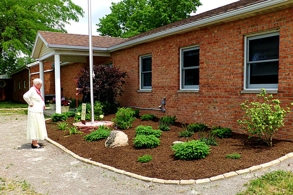 Mrs. Mosher's first look at the new landscaping ar...