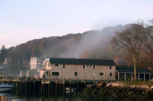 Boat house with fog rolling up and over the roof...