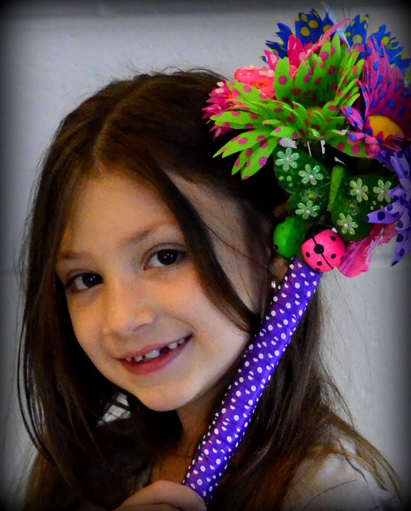 My granddaughter holding bouquet I made her to mat...