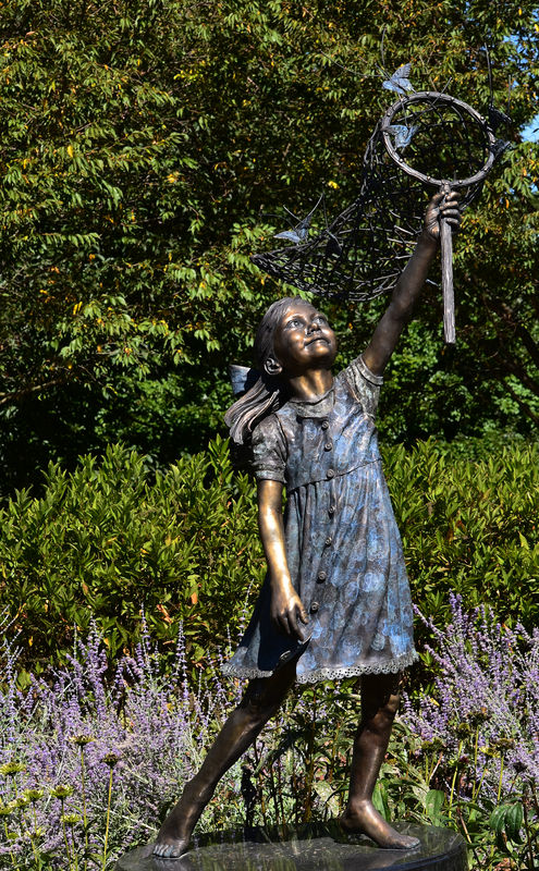 Sculpture of Girl Chasing Butterflliew...