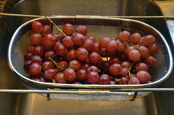 Freshly washed red grapes sparkling in the kitchen...
