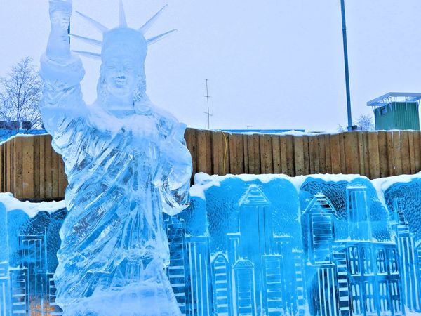 statue of liberty in front of NYC skyline...