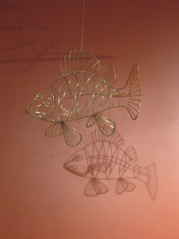 Fish mobile and it's shadow on the wall...