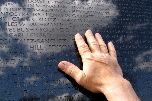 MY husbands hand on the Vietnam Wall underneath th...