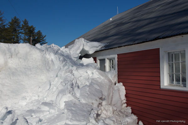 Snow slid off the barn roof and "stopped" against ...