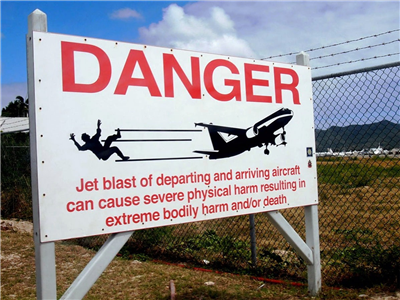 Sign on fence at airport in St. Maarten...