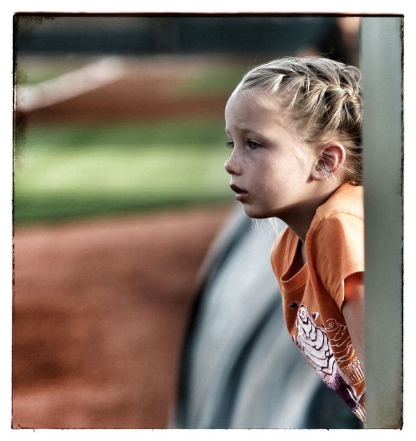 Candid shot of little girl at a baseball game...