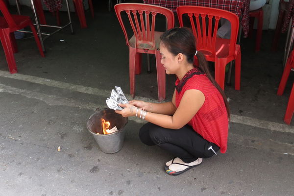 Burning $100 bills, in Saigon for the departed anc...