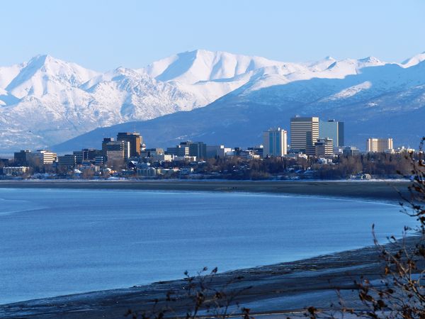 Anchorage, sits on Cook Inlet, surrounded by tall ...