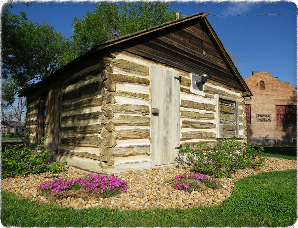 The One Room School House sits outside the Pioneer...