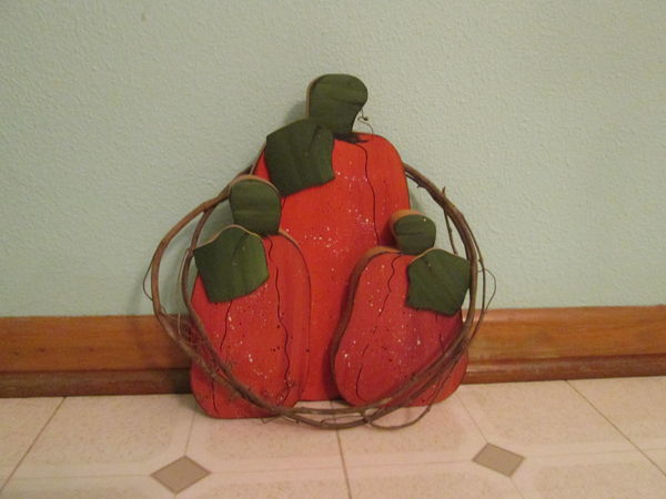 Wooden pumpkins in a vine wreath...