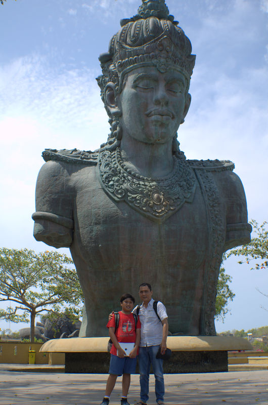 in front of the statue...
