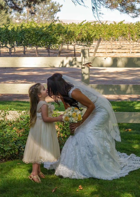 Candid moment between bride and the flower girl .....