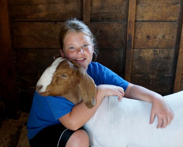 my grand daughter and one of her goats...