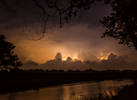 Huge Lightning storm reflected on pond with clear ...