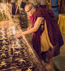 Monk Lighting Prayer Candles...