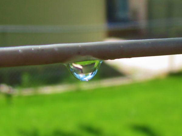 Raindrop clinging to the clothesline...