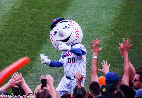 Mr. Met winds up and throws....