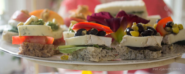 A spot of red on dainty tea sandwiches...