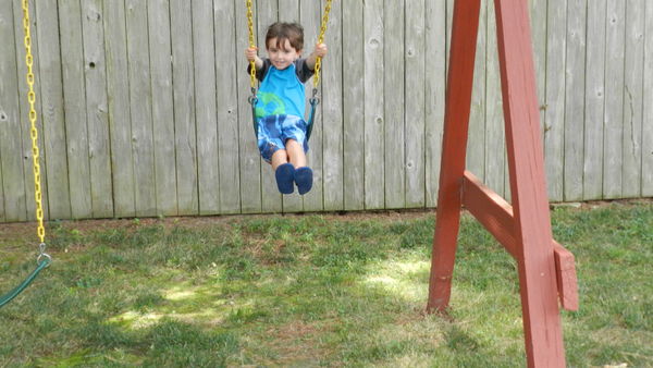 Jack, just turned 5, swinging in his backyard...