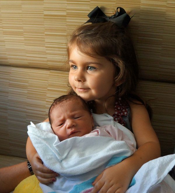 Weatherly holding her little sister...