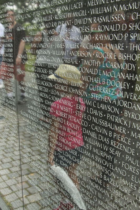 My grand-daughter at the Vietnam  Wall....