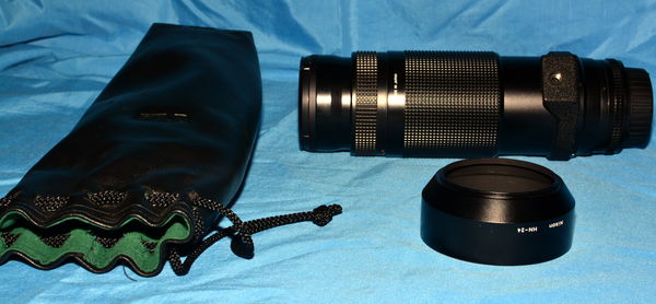 Includes pouch, UV filter, caps and metal hood...