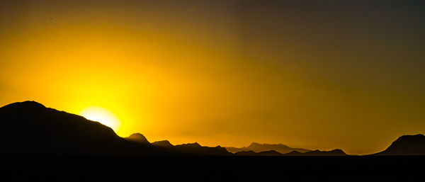 Last rays of the sun illuminating the silhouette o...
