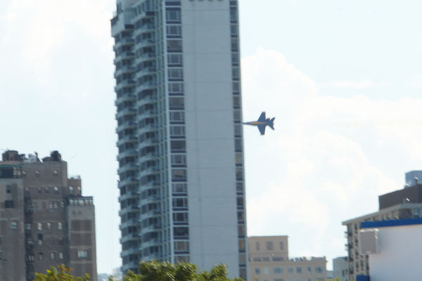 Blue Angel flying past city to turn around...